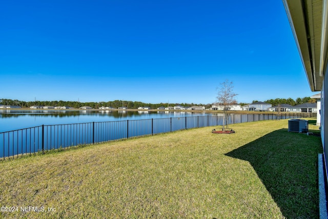 view of yard featuring central AC and a water view