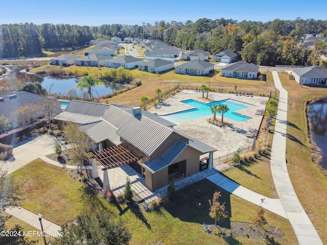 birds eye view of property with a water view