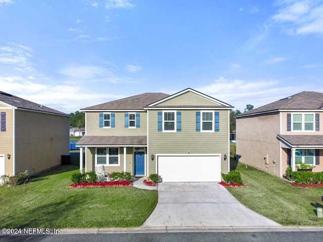 view of front of house with a garage and a front lawn