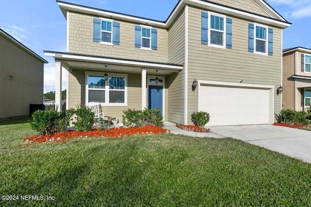 view of front of home with a garage and a front lawn