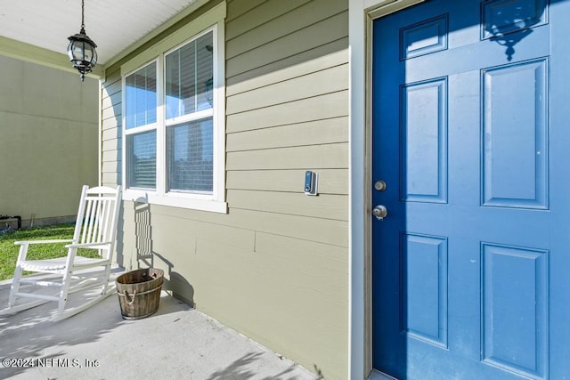 doorway to property featuring covered porch