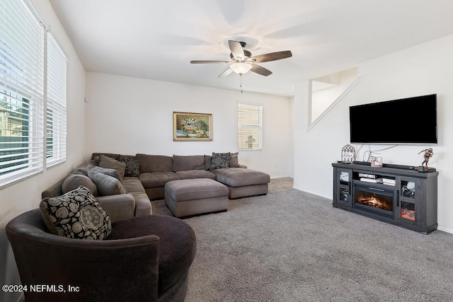 carpeted living room with ceiling fan