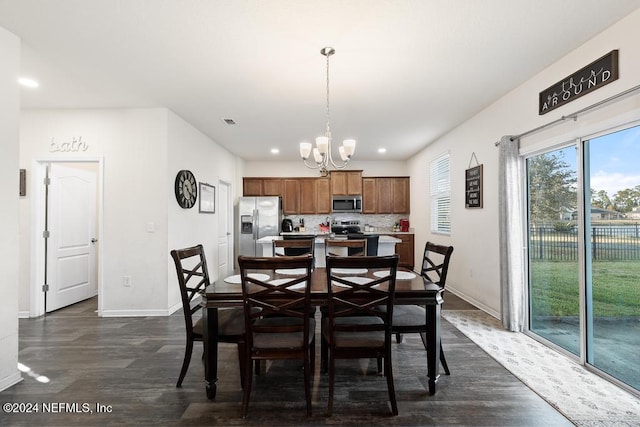 dining area featuring dark hardwood / wood-style floors and a notable chandelier