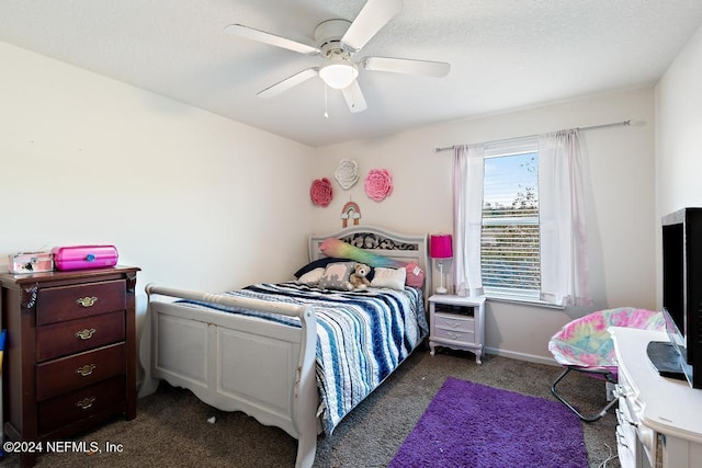 bedroom with dark colored carpet and ceiling fan