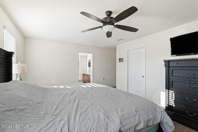 bedroom with carpet, connected bathroom, and ceiling fan