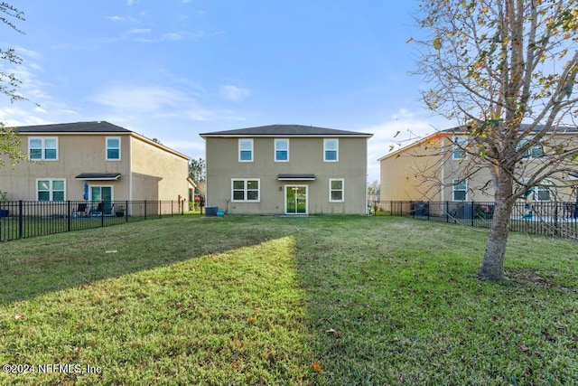 back of property featuring a lawn