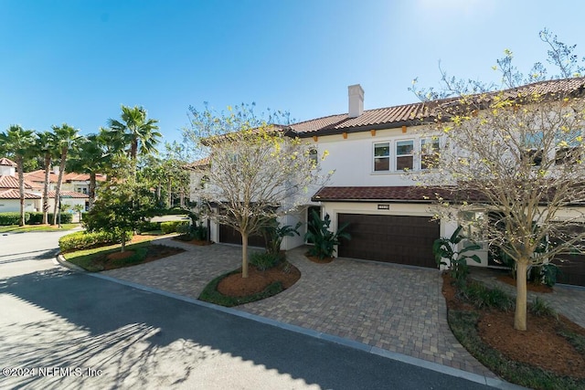 mediterranean / spanish-style home with a garage