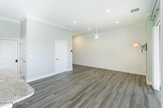 empty room featuring ceiling fan, dark hardwood / wood-style flooring, and ornamental molding