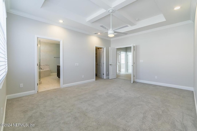 unfurnished bedroom featuring light carpet, ensuite bath, a spacious closet, and ornamental molding