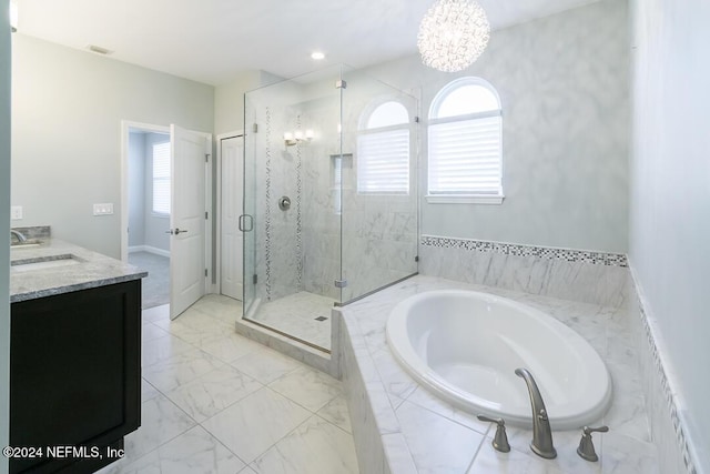 bathroom with a chandelier, vanity, separate shower and tub, and a healthy amount of sunlight