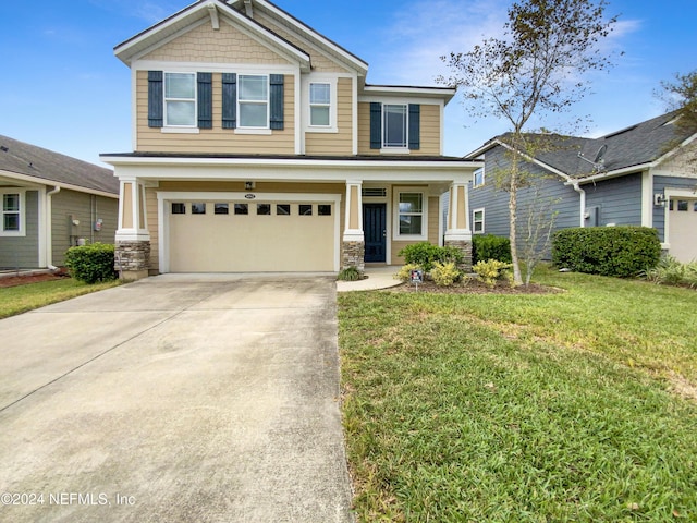 craftsman house featuring a garage and a front yard