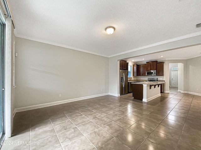 unfurnished living room with light tile patterned floors, a textured ceiling, and ornamental molding