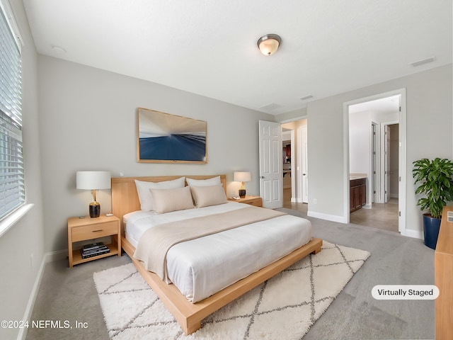 carpeted bedroom with connected bathroom