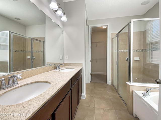 bathroom with plus walk in shower, vanity, and tile patterned floors