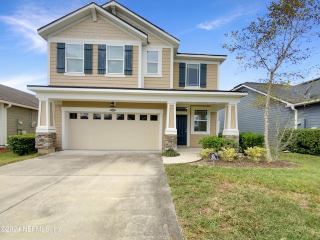 craftsman house featuring a front lawn and a garage