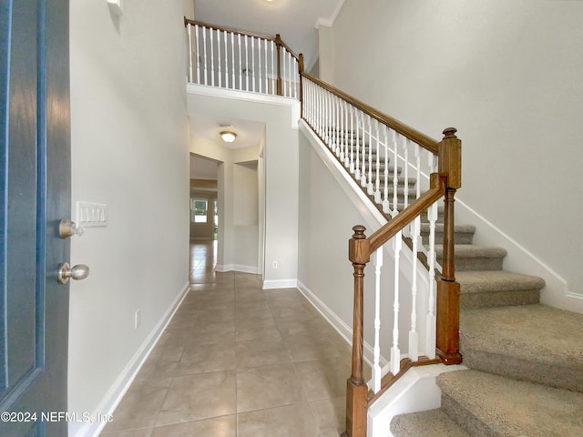 foyer featuring a towering ceiling and tile patterned floors