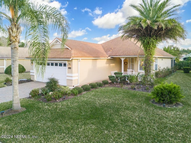 view of front of home with a garage and a front lawn