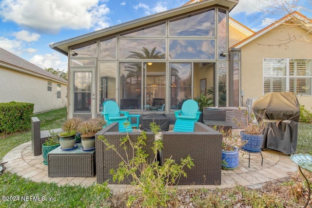 back of house featuring a sunroom and a patio