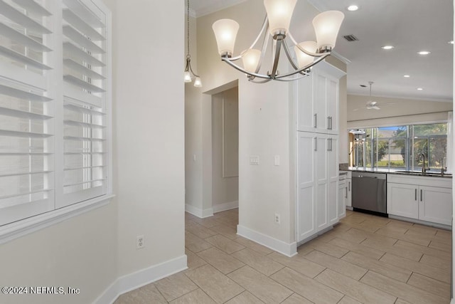 kitchen featuring dishwasher, white cabinets, ceiling fan with notable chandelier, sink, and vaulted ceiling