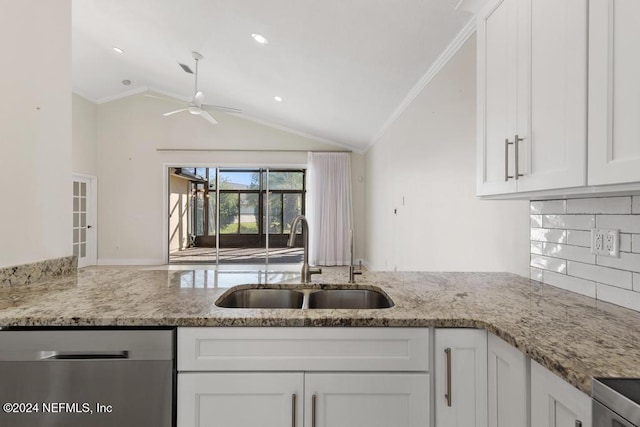 kitchen with dishwasher, lofted ceiling, backsplash, white cabinets, and sink