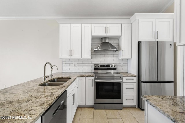 kitchen featuring white cabinetry, sink, stainless steel appliances, wall chimney range hood, and light stone counters