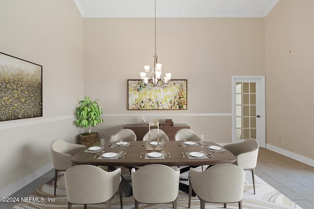 dining space with crown molding and an inviting chandelier