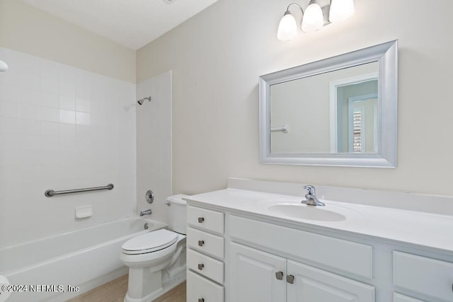 full bathroom with vanity, tiled shower / bath combo, and toilet