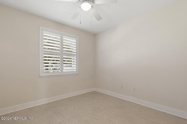 spare room with ceiling fan