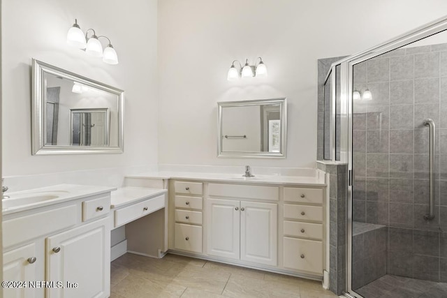 bathroom with vanity, tile patterned floors, and a shower with shower door