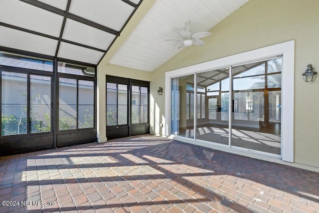 unfurnished sunroom featuring plenty of natural light, ceiling fan, and lofted ceiling