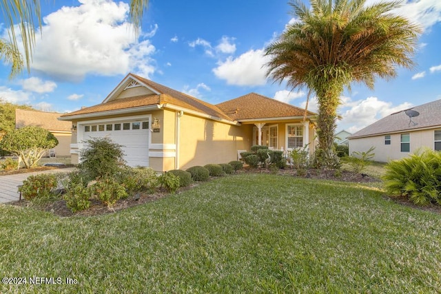 view of front of property featuring a front yard and a garage