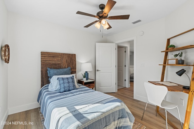 bedroom with ceiling fan and wood-type flooring