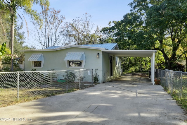 view of side of property with a carport