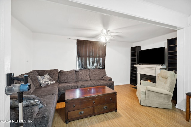 living room featuring ceiling fan and light hardwood / wood-style flooring