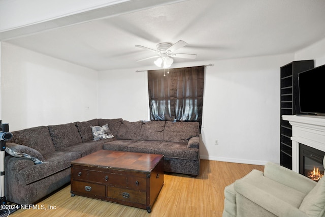 living room featuring ceiling fan and light hardwood / wood-style flooring