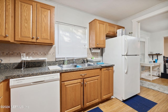 kitchen with decorative backsplash, sink, light hardwood / wood-style floors, and white appliances