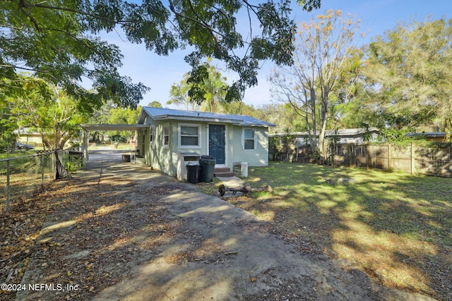 exterior space featuring a carport and a lawn