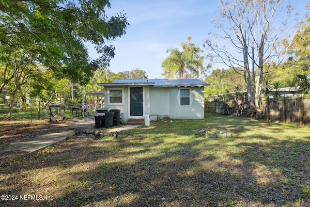 back of house with a lawn