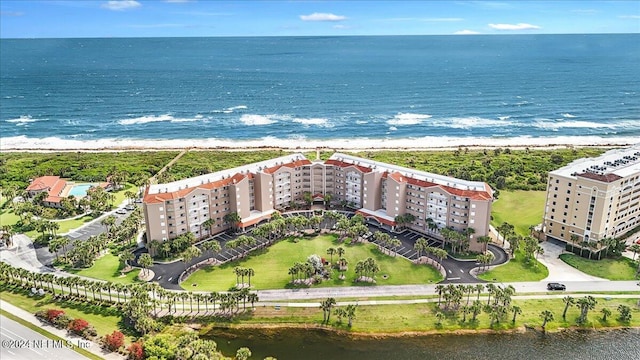 birds eye view of property featuring a water view and a view of the beach