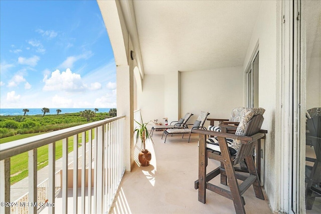 balcony featuring a water view