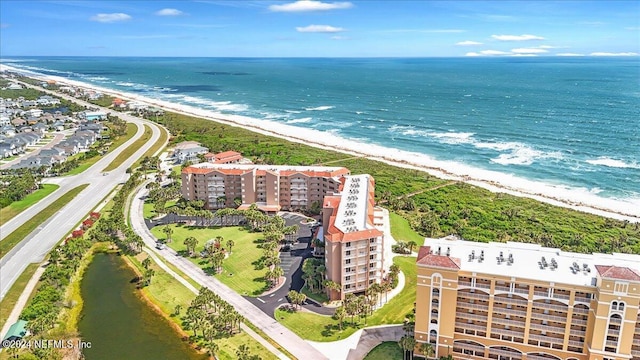 drone / aerial view featuring a water view and a view of the beach