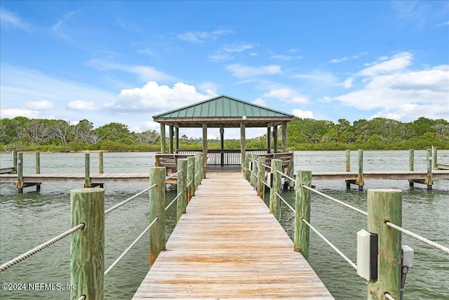 view of dock featuring a gazebo and a water view