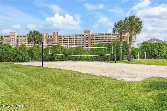 view of community with a lawn and volleyball court