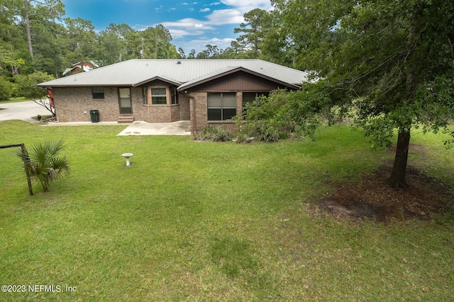 rear view of house featuring a patio area and a yard