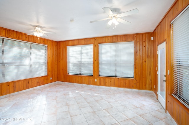 unfurnished sunroom featuring ceiling fan