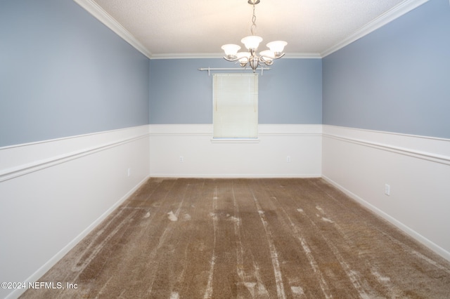 carpeted spare room with a textured ceiling, a notable chandelier, and crown molding