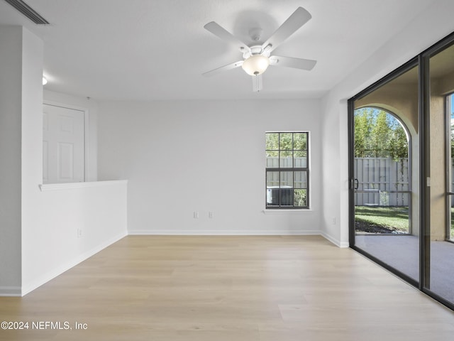 unfurnished room with ceiling fan and light hardwood / wood-style flooring