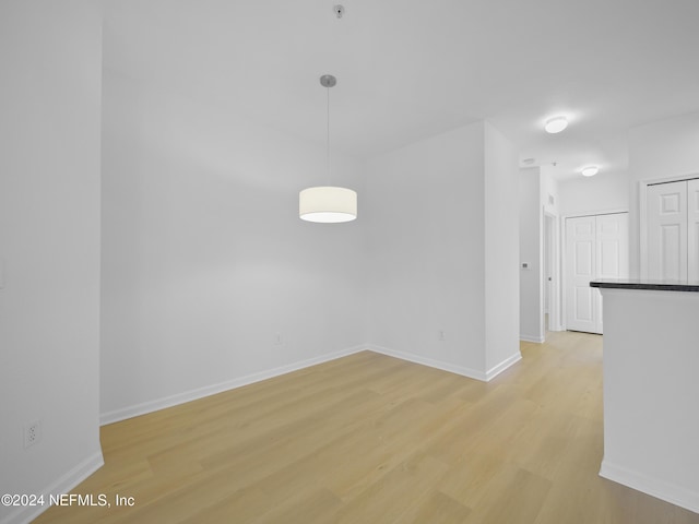 unfurnished room with light wood-type flooring