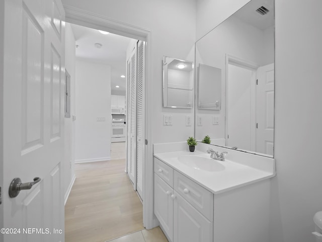 bathroom featuring hardwood / wood-style floors and vanity