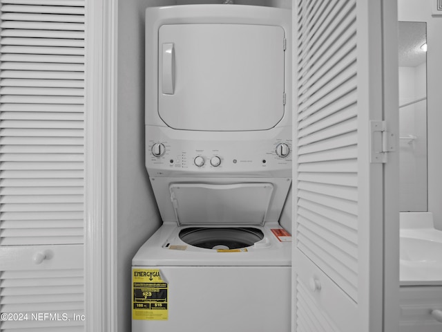 clothes washing area with stacked washer / drying machine